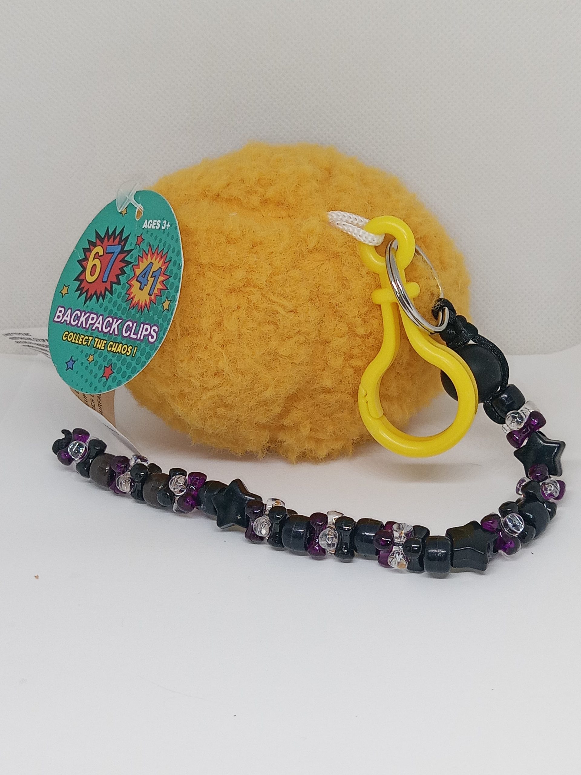 Back view of Number 67 plush backpack clip
