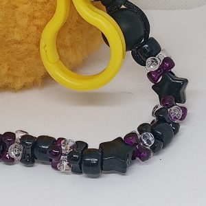Close-up of purple black and clear bead keychain