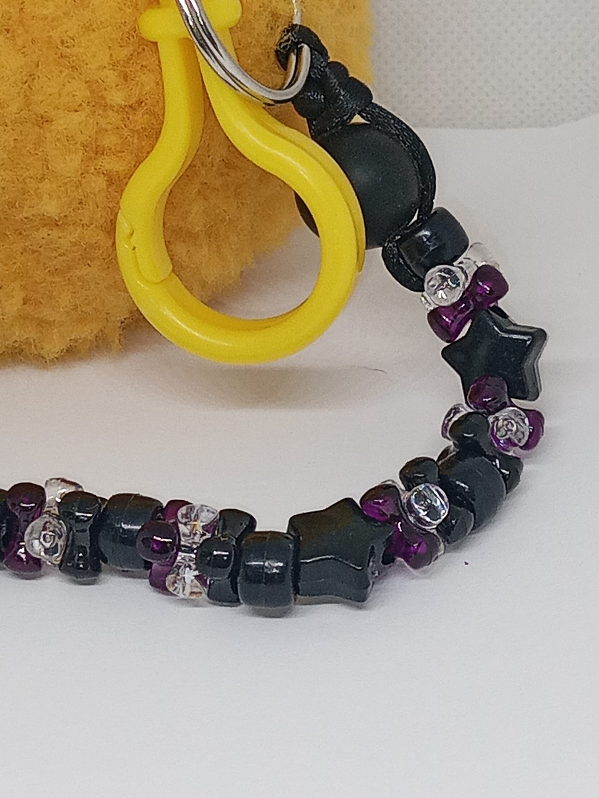 Close-up of purple black and clear bead keychain